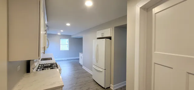 a kitchen with a sink a counter top space stainless steel appliances