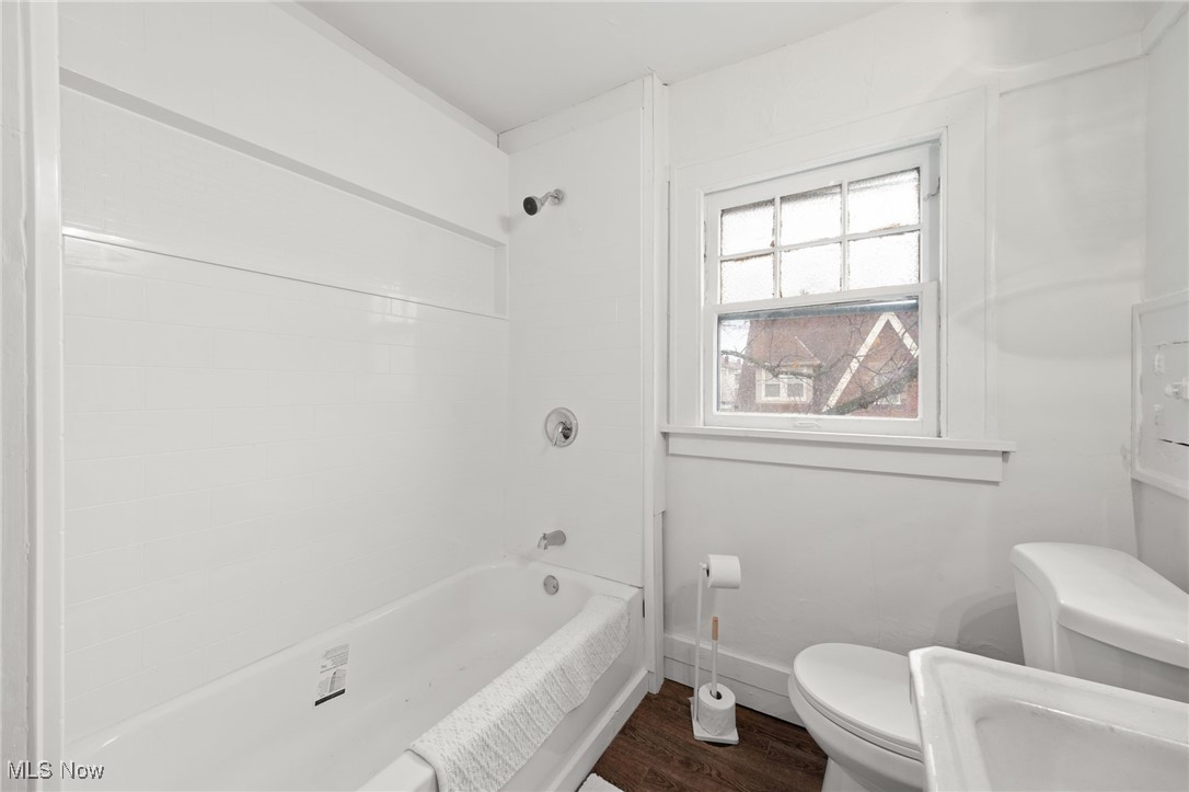 1857 Willowhurst Road Cleveland, OH 44112 - Photo 20 of 26 Bathroom with hardwood / wood-style flooring, toilet, and shower / washtub combination