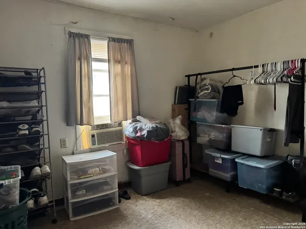 a bedroom with furniture and a flat screen tv