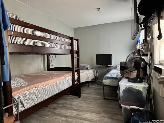 a bedroom with furniture and a window