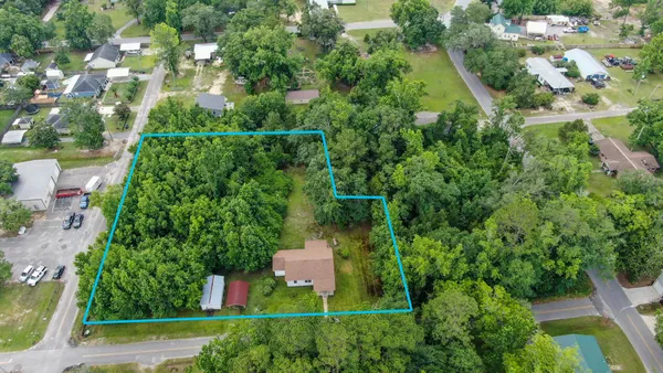 an aerial view of a house with yard