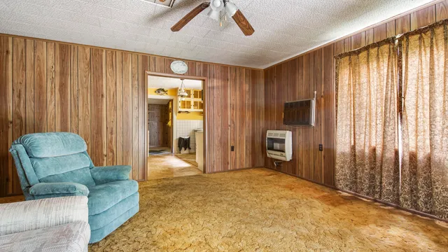 a bedroom with furniture and a large window