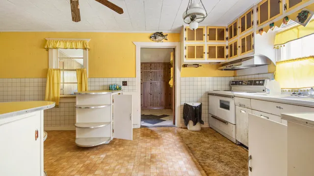 a kitchen with a refrigerator and stove
