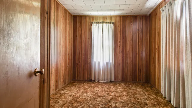 a view of an empty room and a window