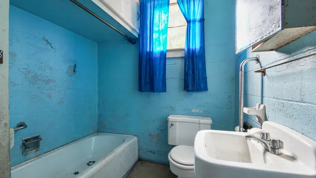 a bathroom with a sink a toilet and bathtub