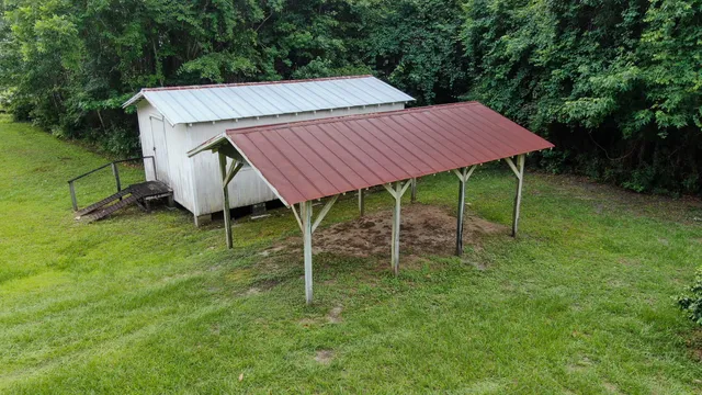 a backyard of a house with table and chairs