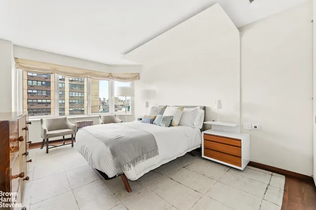 a view of a hallway with wooden floor and windows
