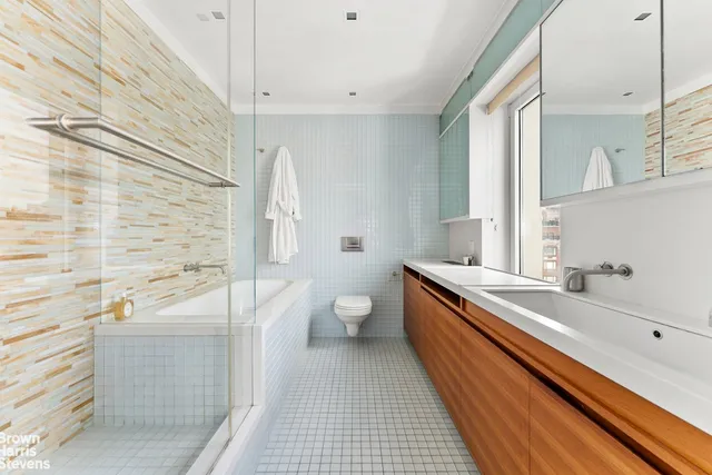 a spacious bedroom with a bed and large windows