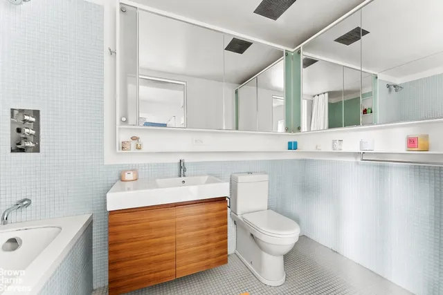 a bedroom with furniture and a large window