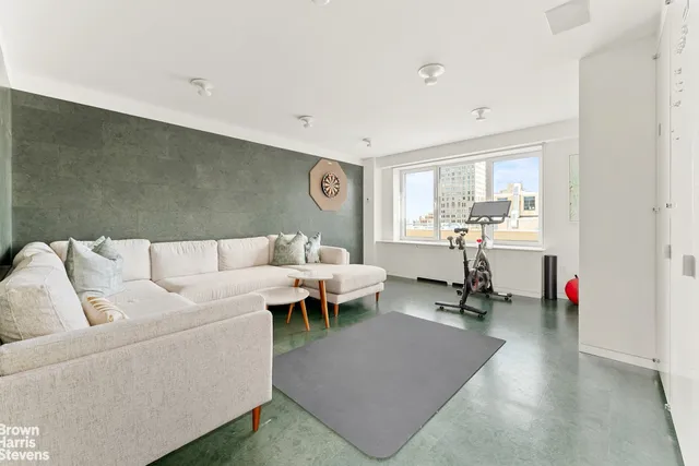 a white toilet sitting next to a bathroom sink and vanity