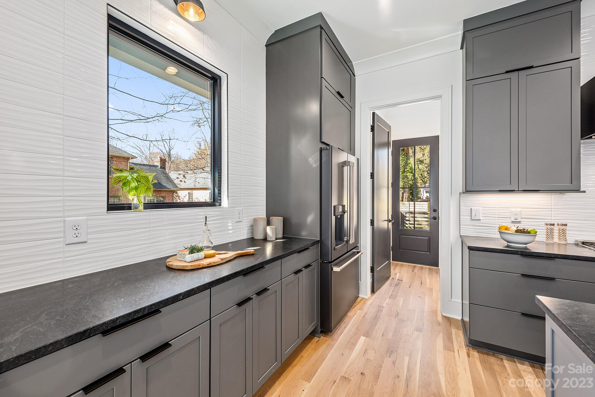 4338 Castleton Road Charlotte, NC 28211 - Photo 11 of 38 a kitchen with stainless steel appliances a sink stove and refrigerator
