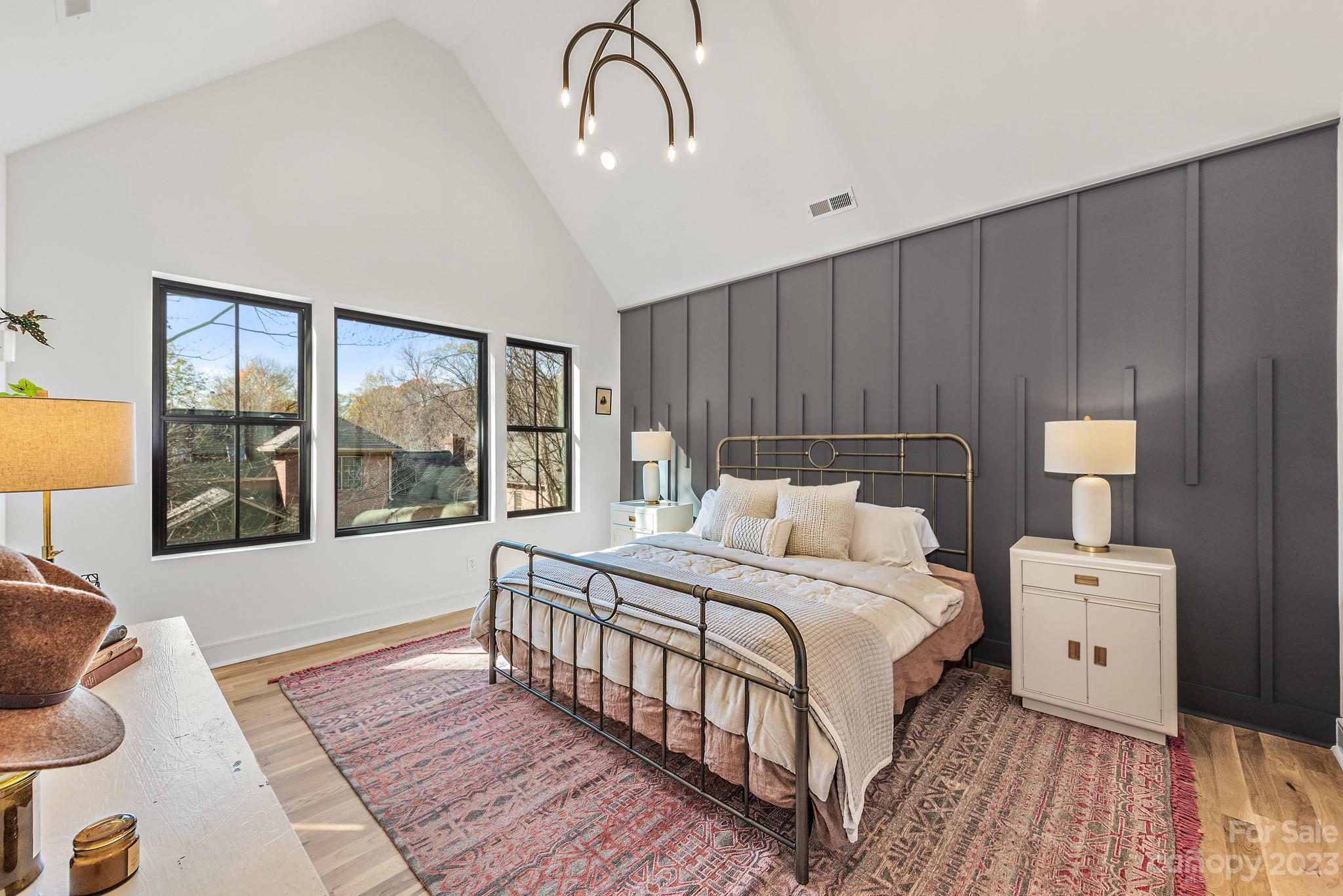 4338 Castleton Road Charlotte, NC 28211 - Photo 15 of 38 a bedroom with a bed a mirror and a window