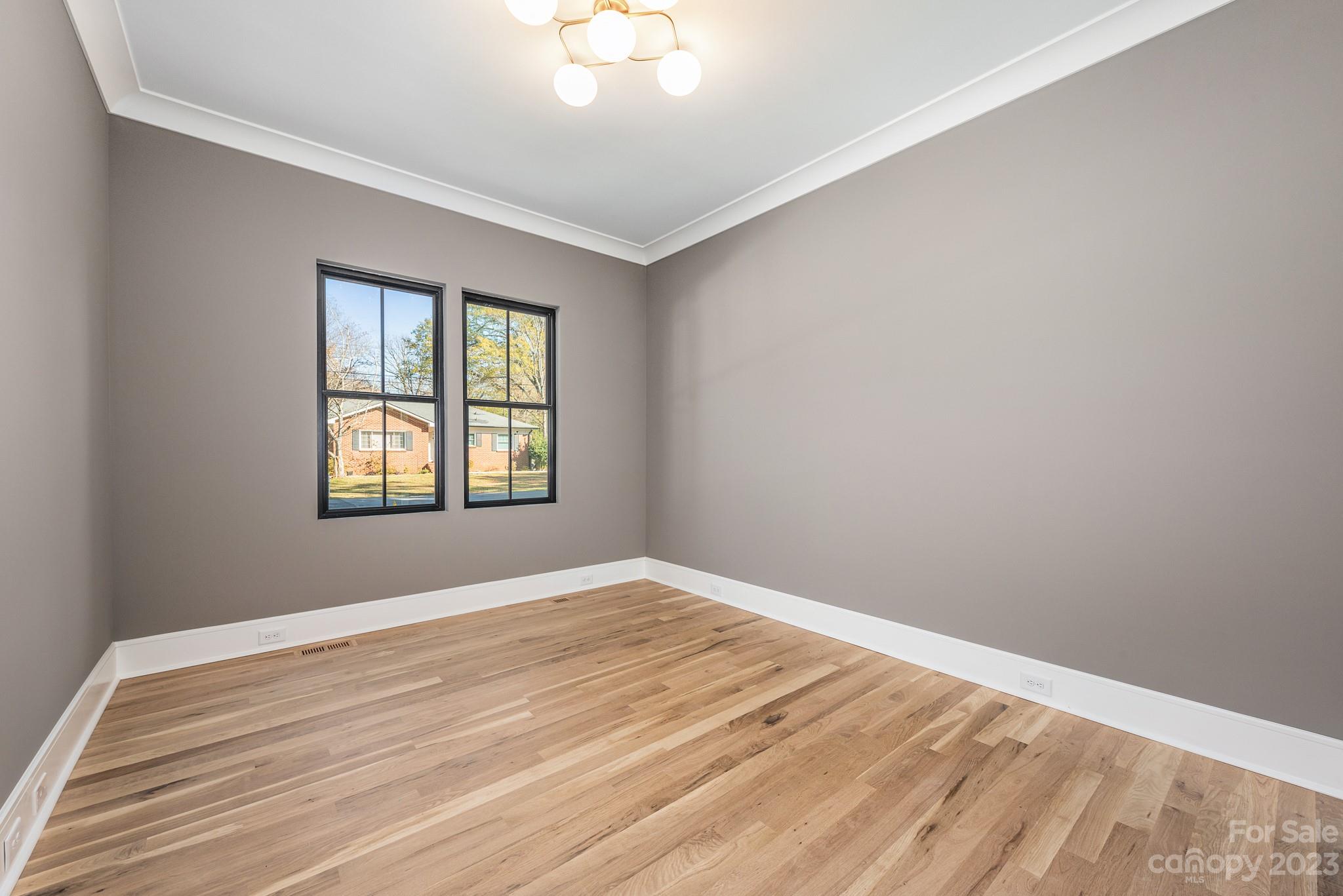 4338 Castleton Road Charlotte, NC 28211 - Photo 22 of 38 a view of an empty room with wooden floor and a window