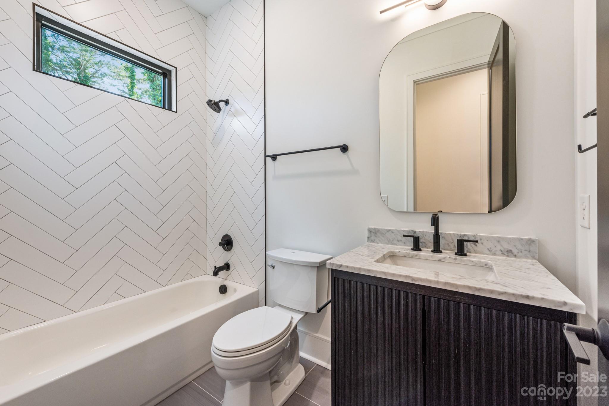 4338 Castleton Road Charlotte, NC 28211 - Photo 23 of 38 a bathroom with a sink and a mirror