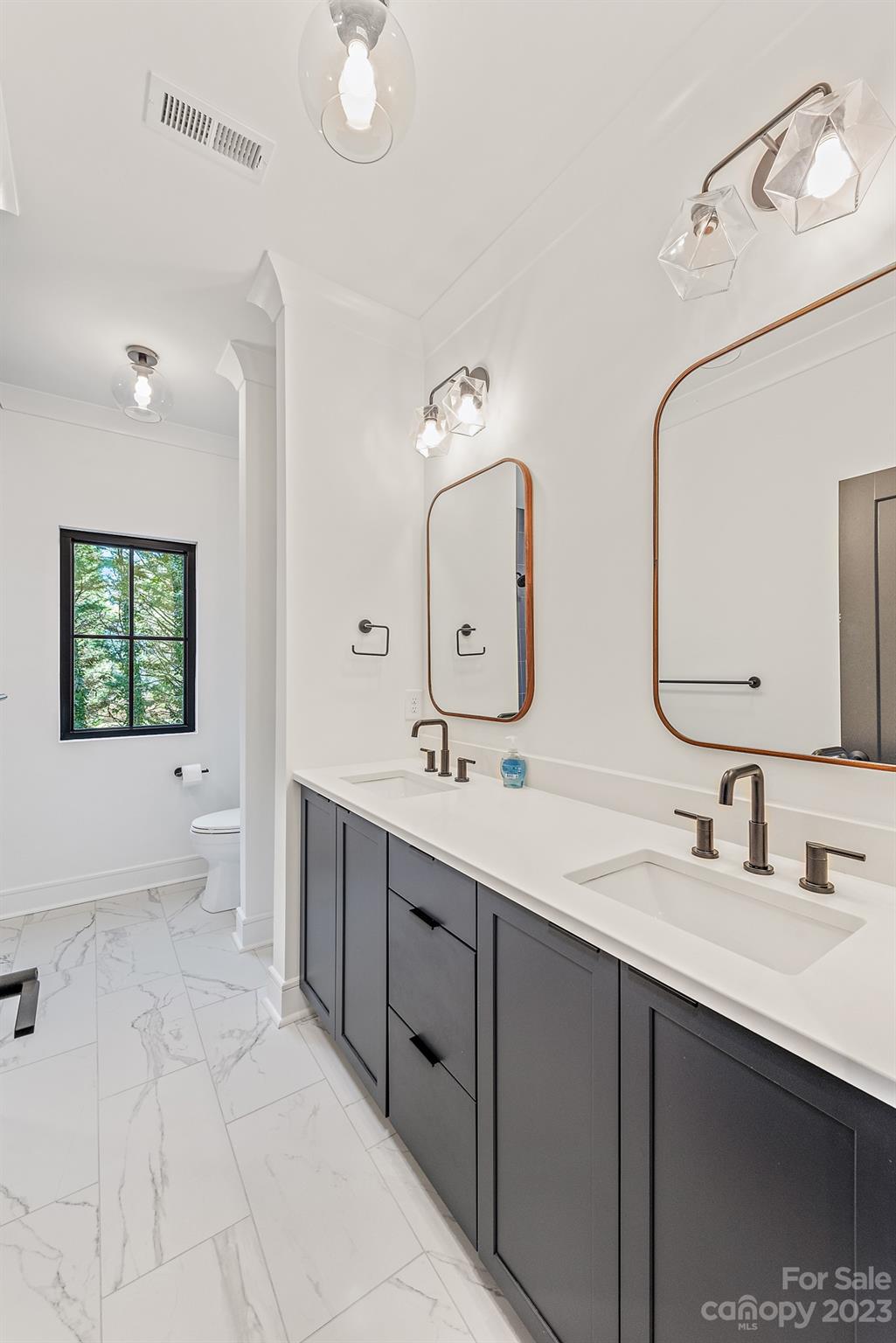 4338 Castleton Road Charlotte, NC 28211 - Photo 27 of 38 a bathroom with a double vanity sink mirror and a bathtub