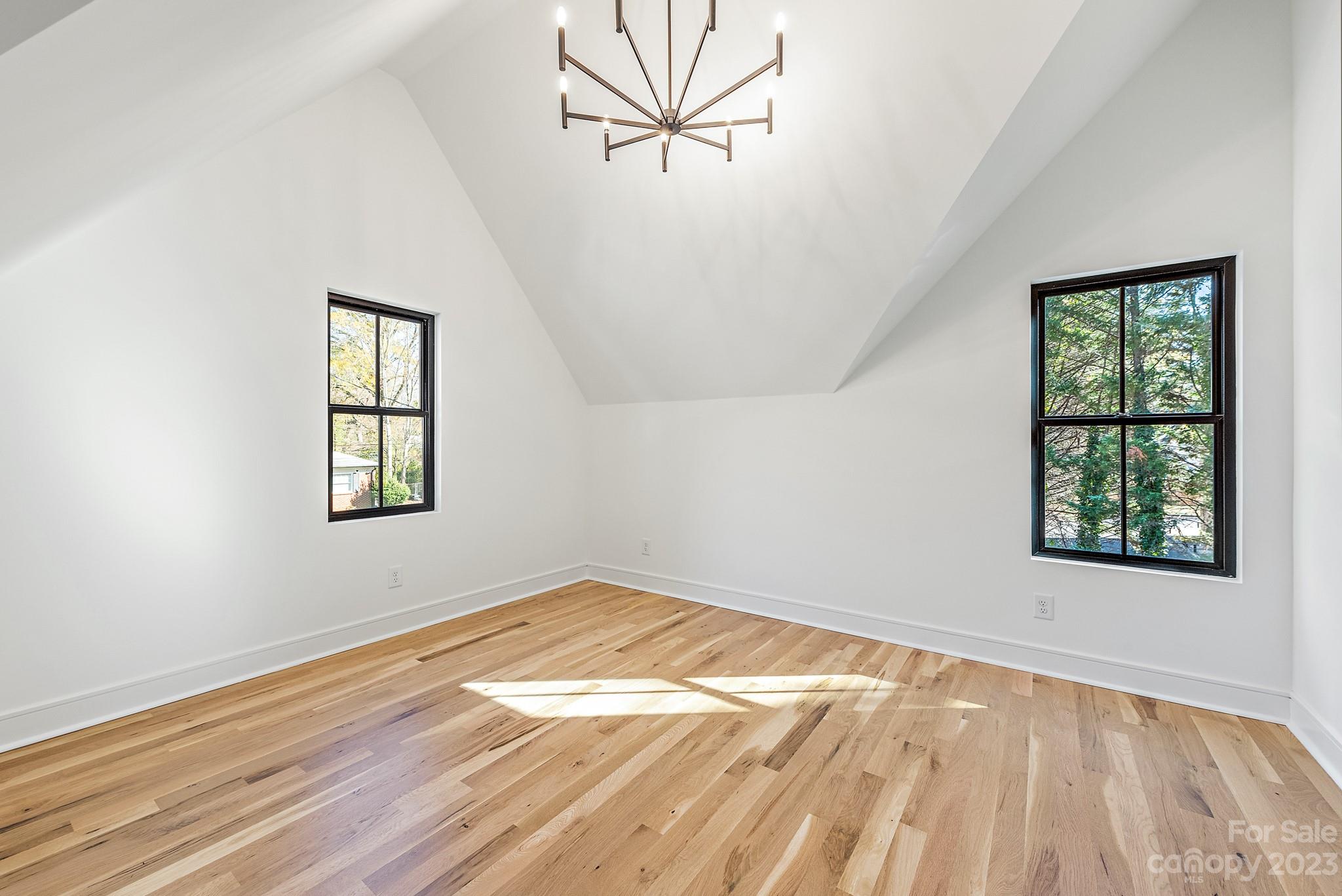 4338 Castleton Road Charlotte, NC 28211 - Photo 29 of 38 an empty room with wooden floor and windows