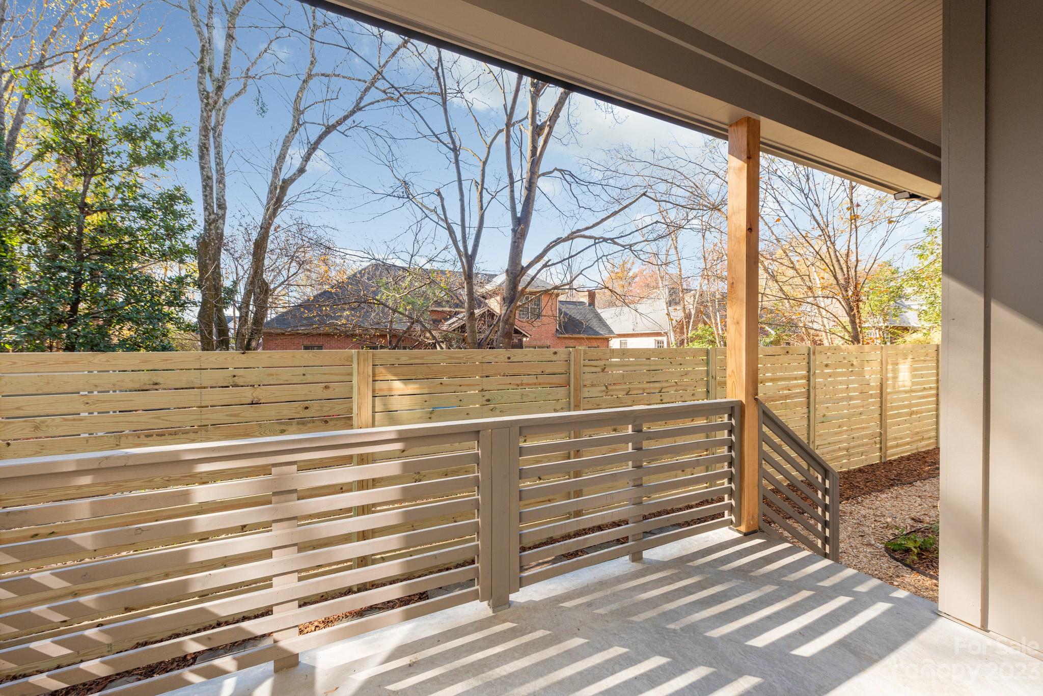 4338 Castleton Road Charlotte, NC 28211 - Photo 35 of 38 a view of a balcony with floor to ceiling windows and wooden fence