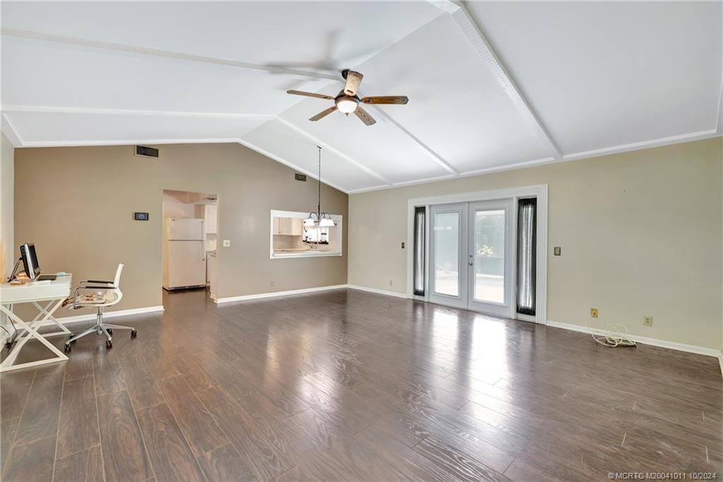 6806 Southwest Chase Court Stuart, FL 34997 - Photo 7 of 37 Spacious Living Room with French Doors Leading to the Enclosed Pool