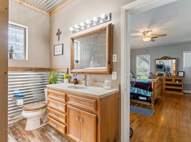 a bathroom with a sink a toilet and a mirror