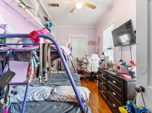 a bedroom with furniture and a flat screen tv