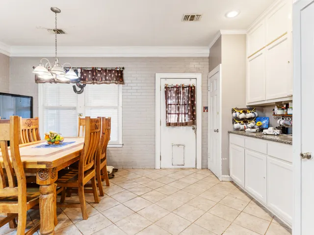 a view of a dining room with furniture and chandelier