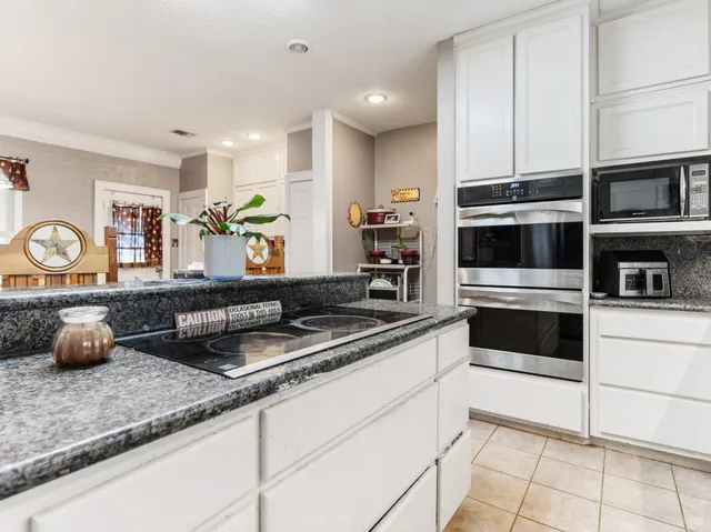a kitchen with counter top space cabinets and stainless steel appliances