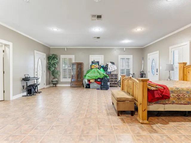 a bedroom with furniture and a large window