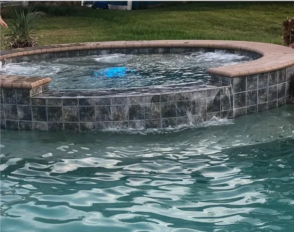 a view of a swimming pool with a yard