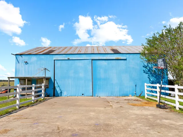 a view of a backyard with wooden fence