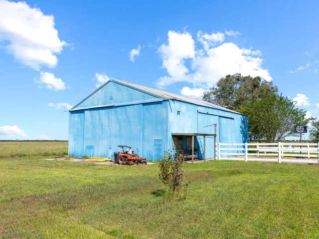 a view of a backyard with table and chairs and potted plants
