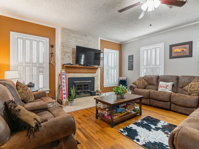 a living room with furniture a fireplace and a window