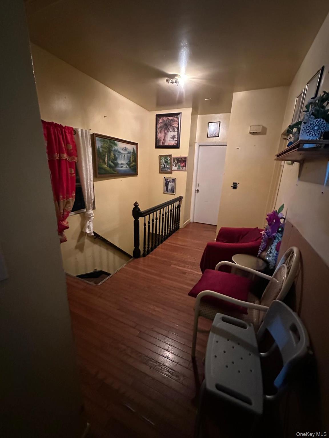 35-44 100th Street Queens, NY 11368 - Photo 2 of 4 a bedroom with furniture and wooden floor