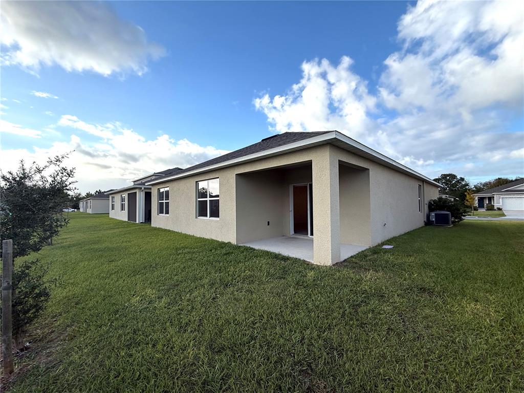 2877 Sunridge Loop St. Cloud, FL 34771 - Photo 19 of 19 a view of a house with backyard
