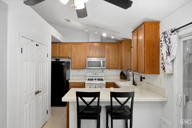 a kitchen that has a table chairs and a refrigerator