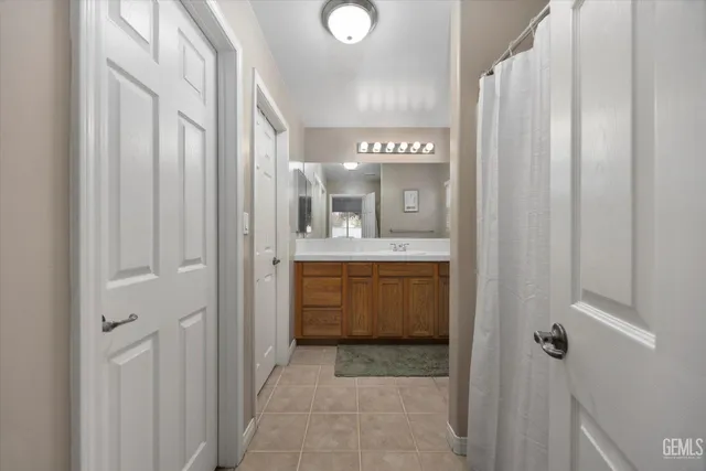 a bathroom with a sink a mirror and a shower