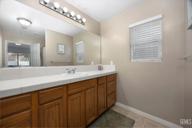a bathroom with a double vanity sink and a mirror