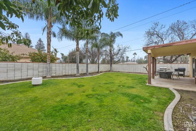a view of a backyard with a garden and fire pit