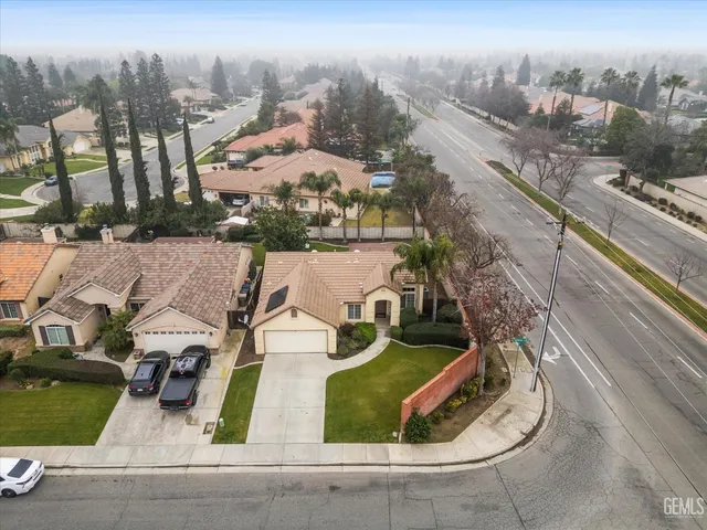an aerial view of a house with garden space and street view