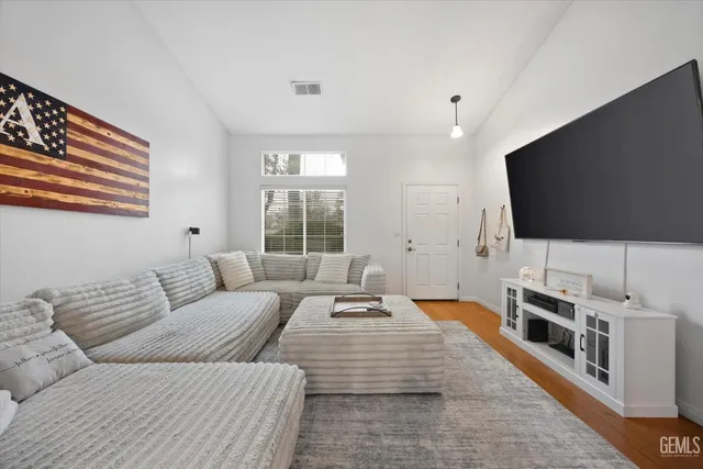 a bedroom with furniture and a flat screen tv