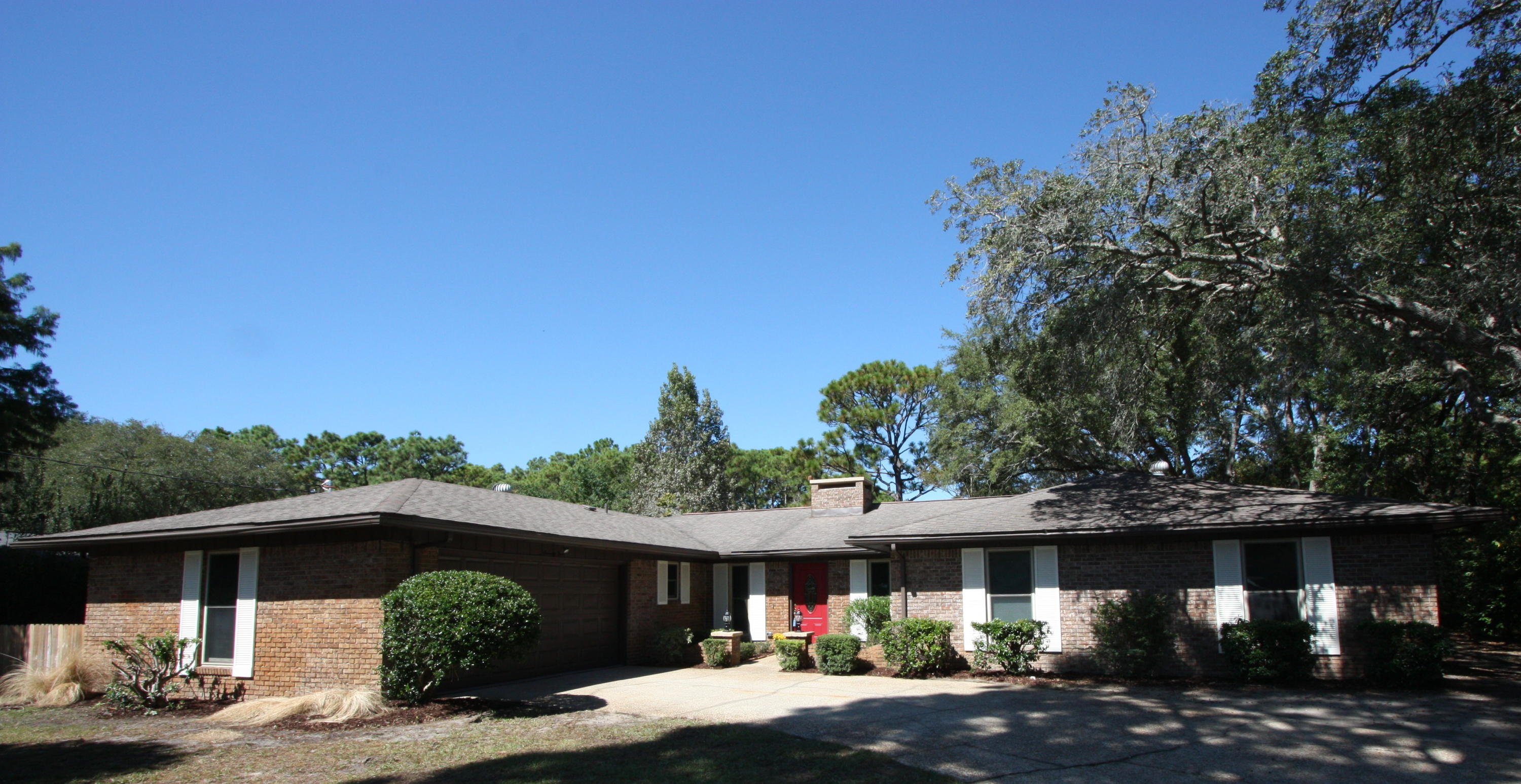 75 Country Club Road Shalimar, FL 32579 - Photo 1 of 24 a front view of a house with a yard