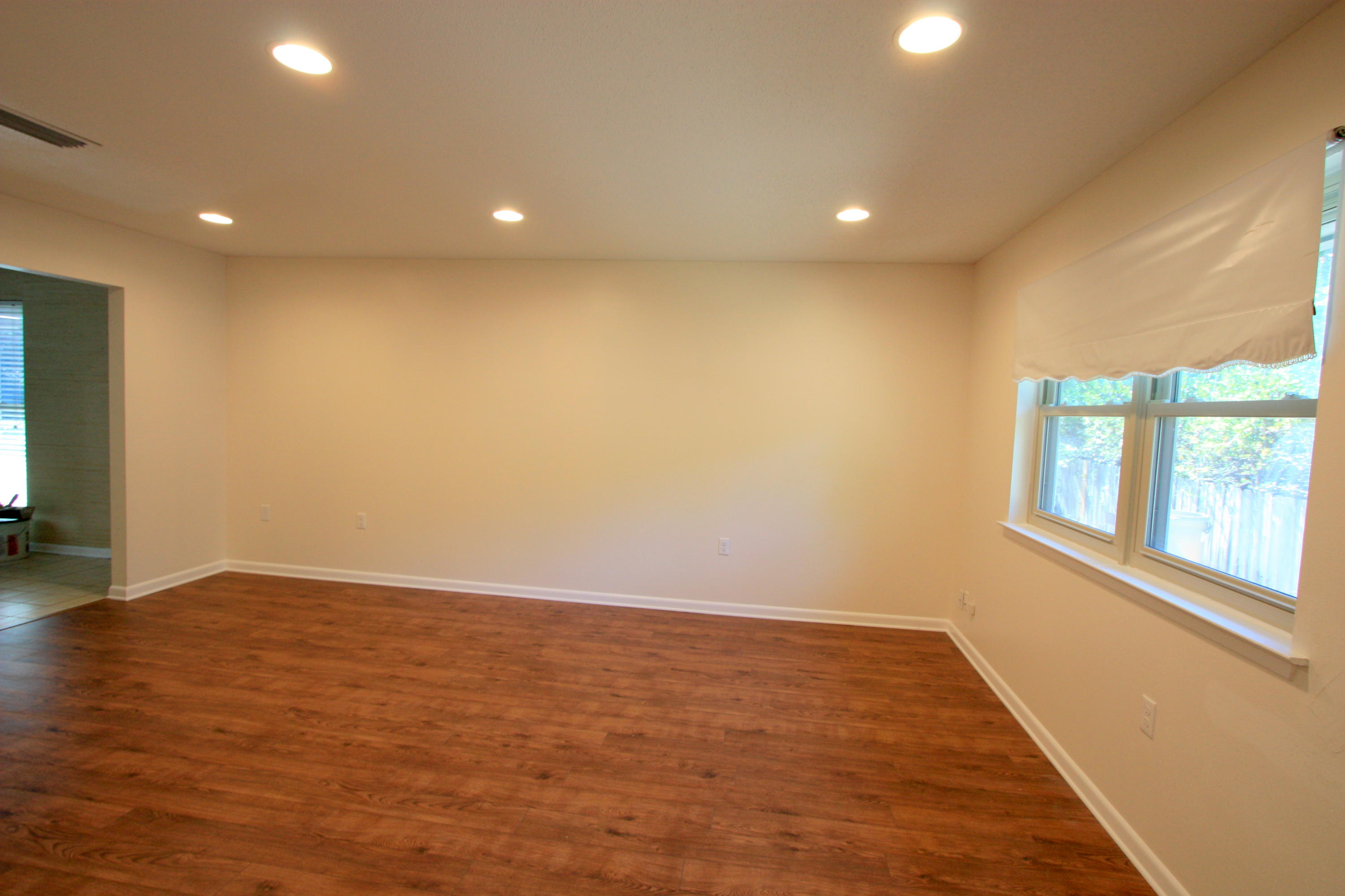 75 Country Club Road Shalimar, FL 32579 - Photo 2 of 24 an empty room with wooden floor and windows