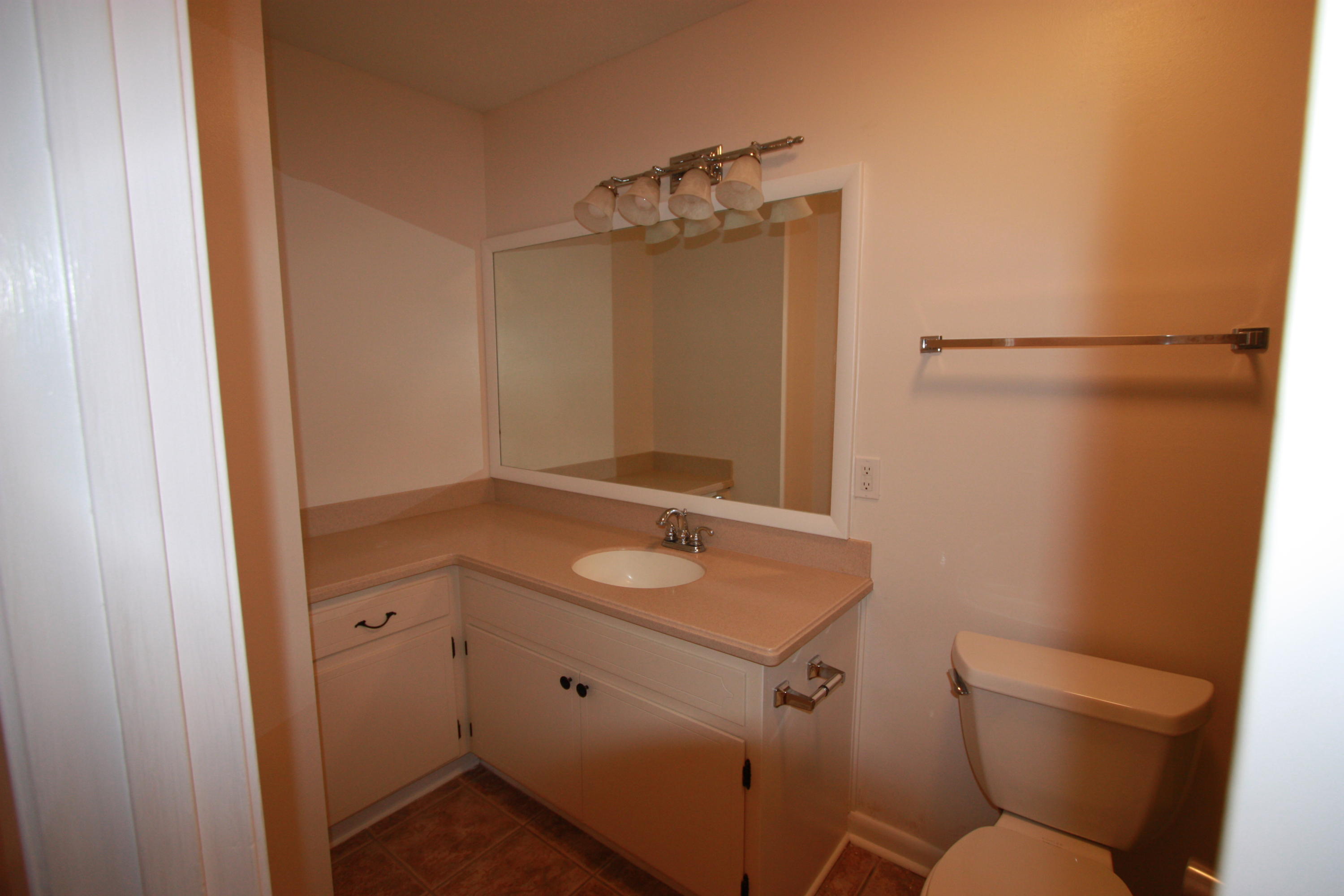 75 Country Club Road Shalimar, FL 32579 - Photo 12 of 24 a bathroom with a granite countertop sink toilet and a mirror