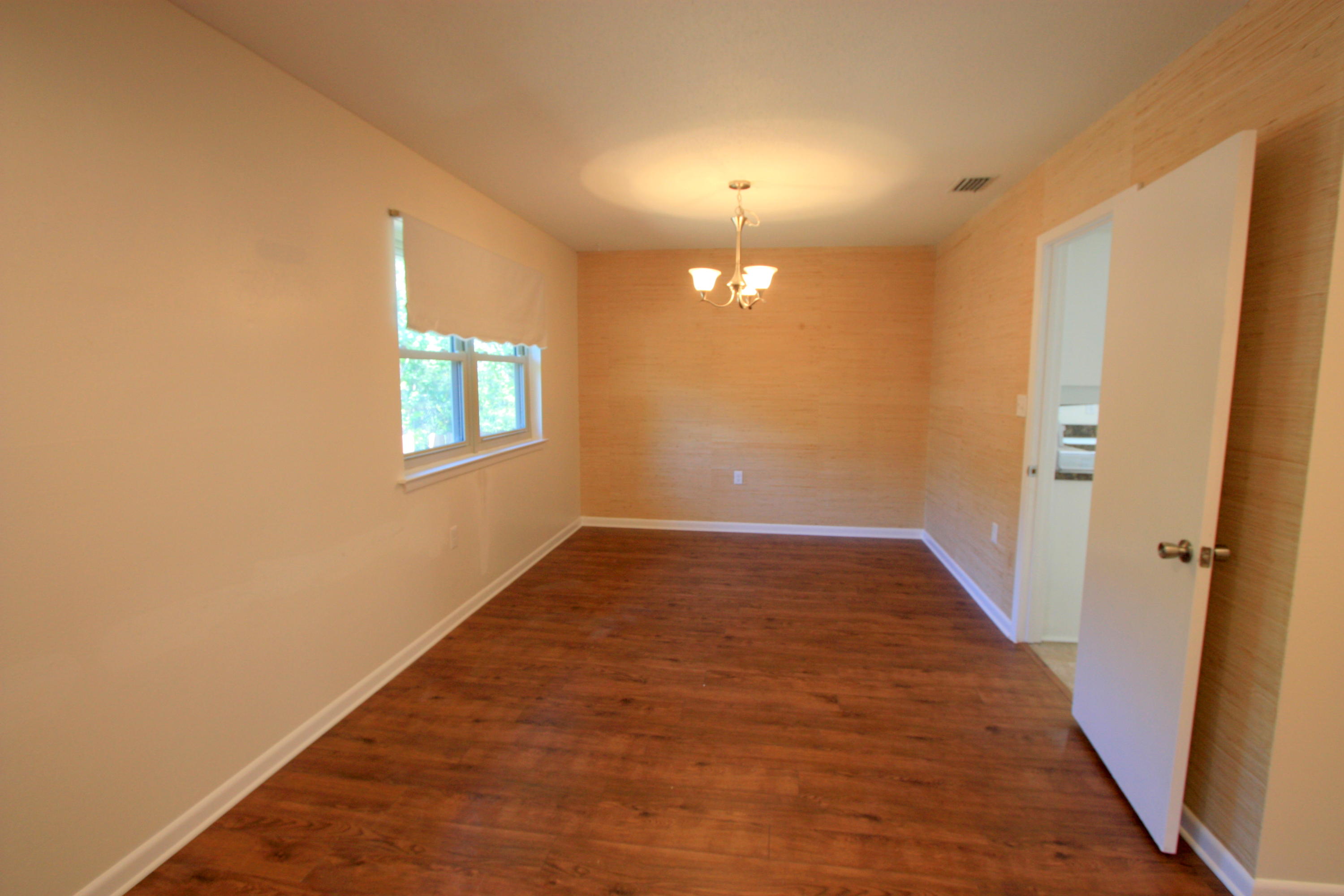 75 Country Club Road Shalimar, FL 32579 - Photo 4 of 24 an empty room with wooden floor and windows