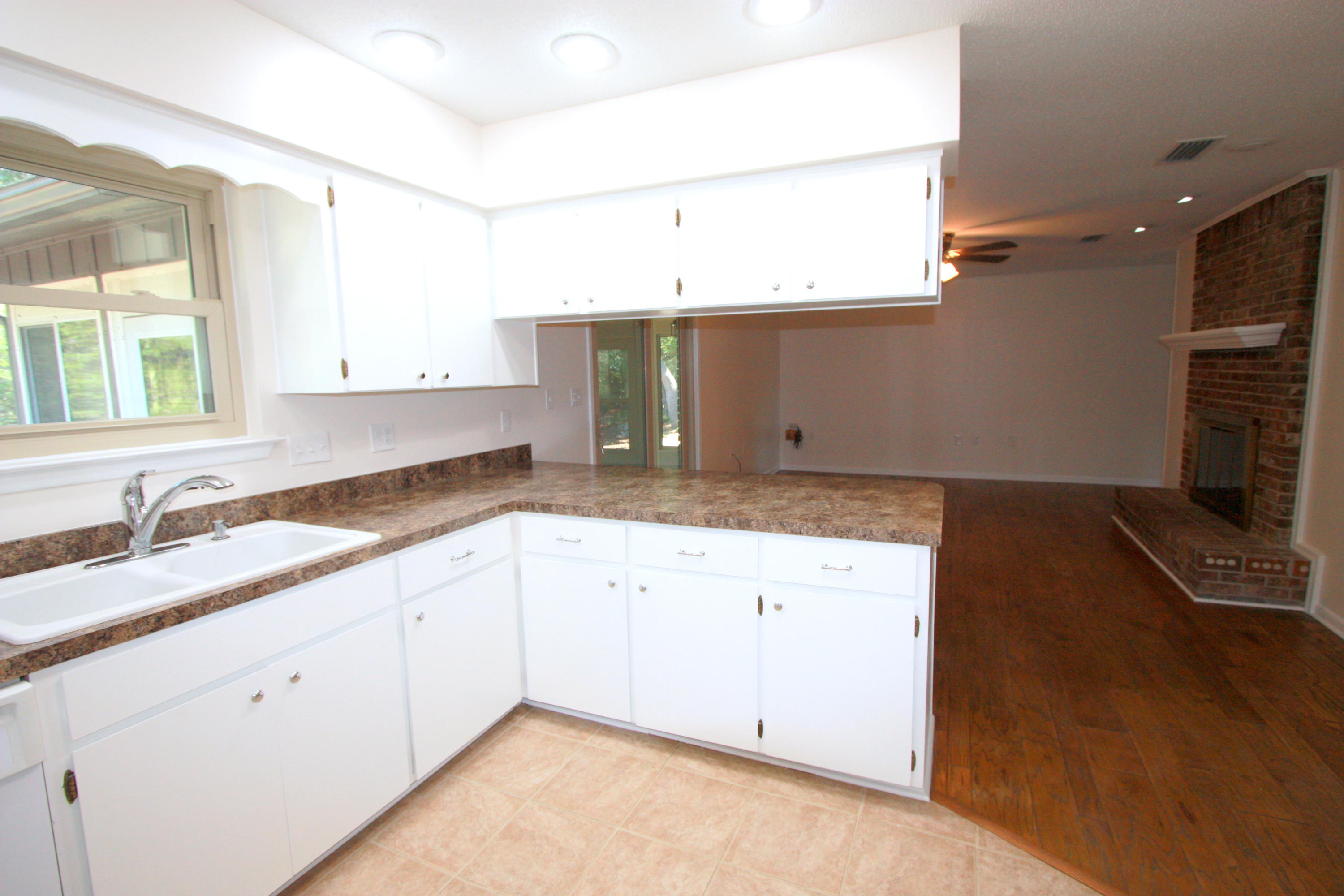 75 Country Club Road Shalimar, FL 32579 - Photo 5 of 24 a kitchen with granite countertop a sink stainless steel appliances and cabinets