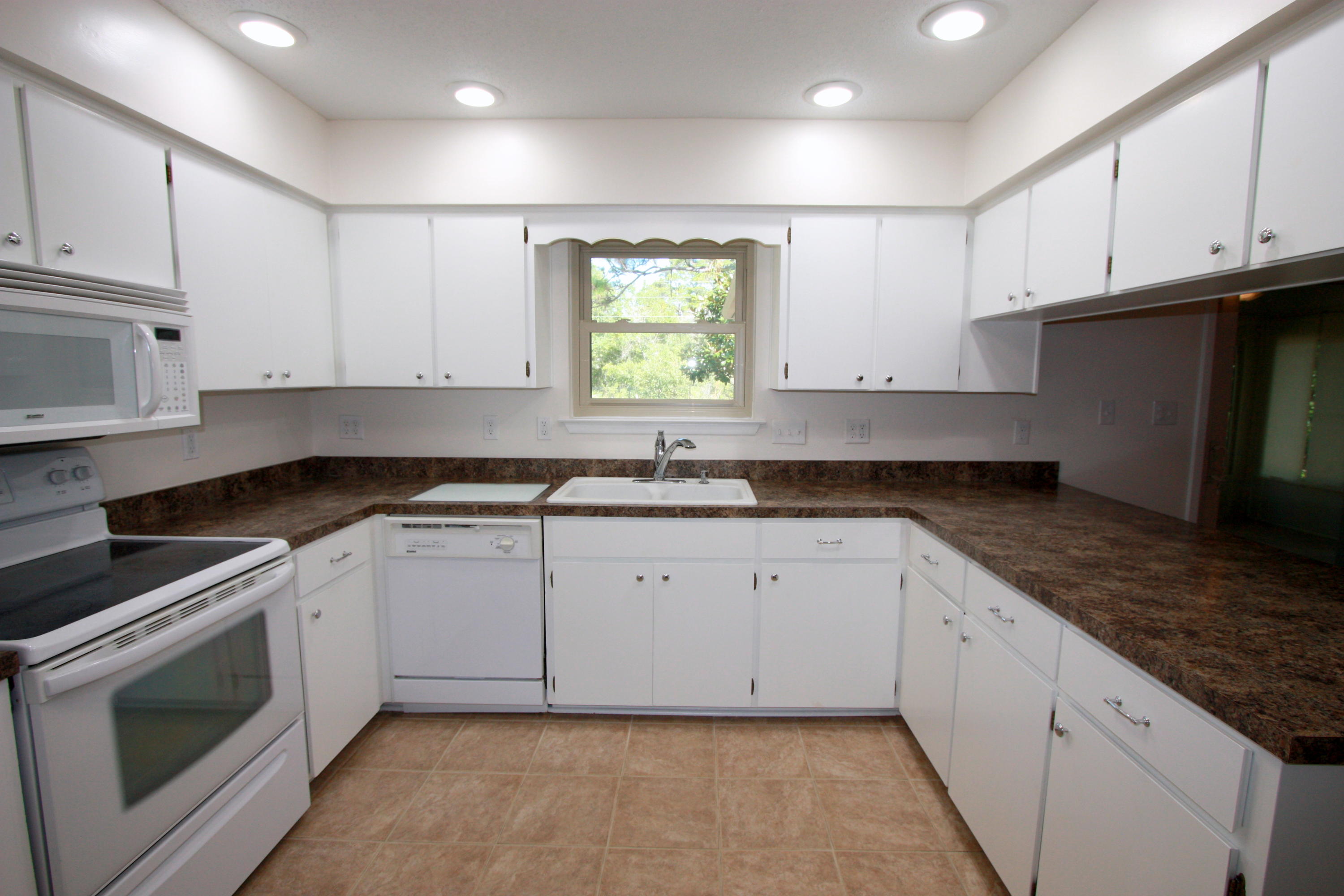 75 Country Club Road Shalimar, FL 32579 - Photo 6 of 24 a kitchen with granite countertop white cabinets white stainless steel appliances and sink