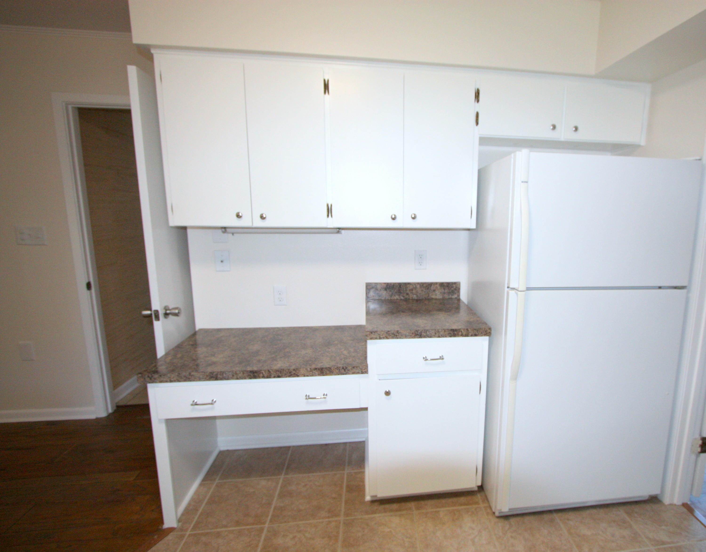 75 Country Club Road Shalimar, FL 32579 - Photo 7 of 24 a kitchen with white cabinets and refrigerator