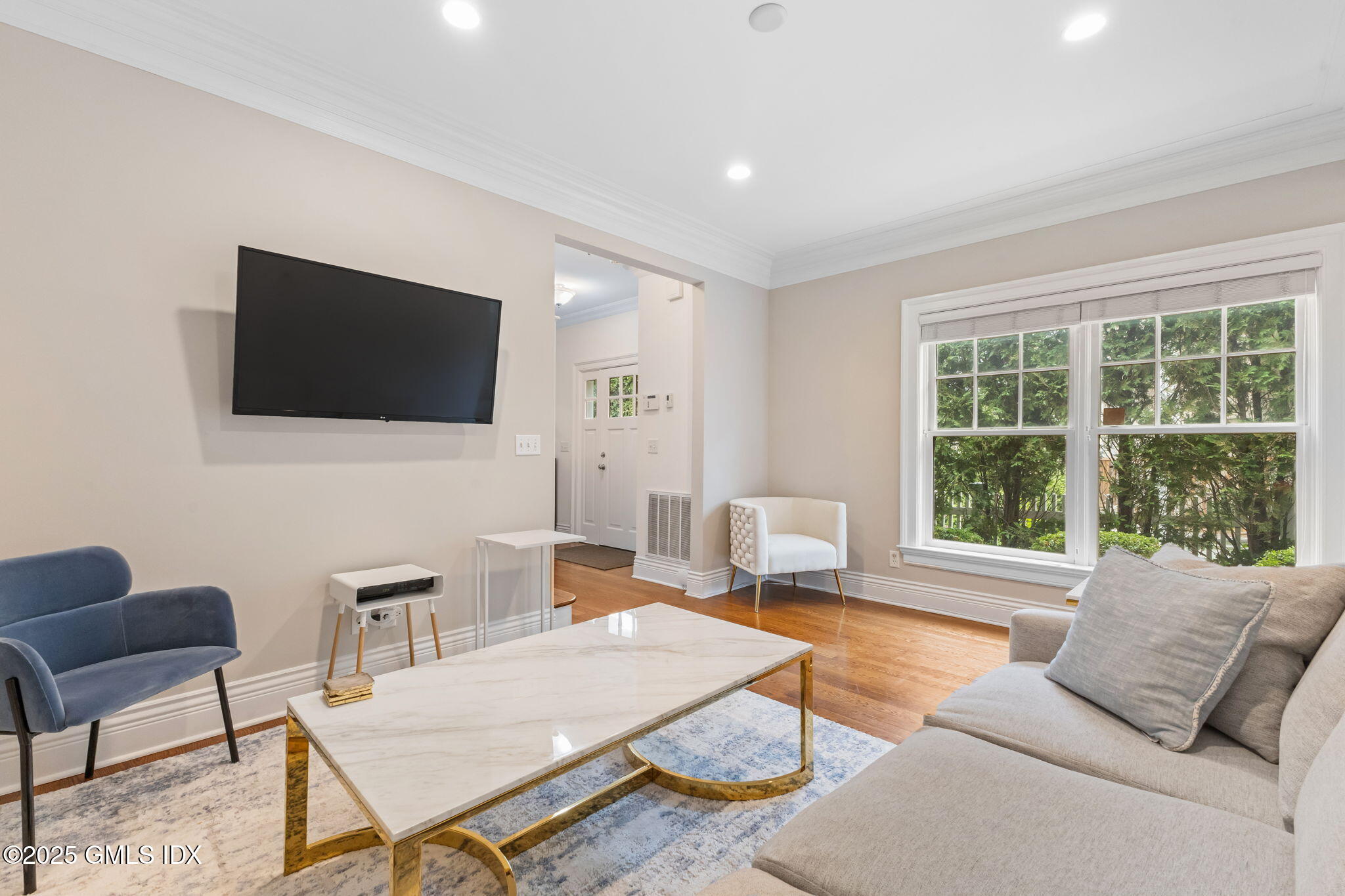 26 Church Street, Unit B Greenwich, CT 06830 - Photo 11 of 30 a living room with furniture a flat screen tv and a large window