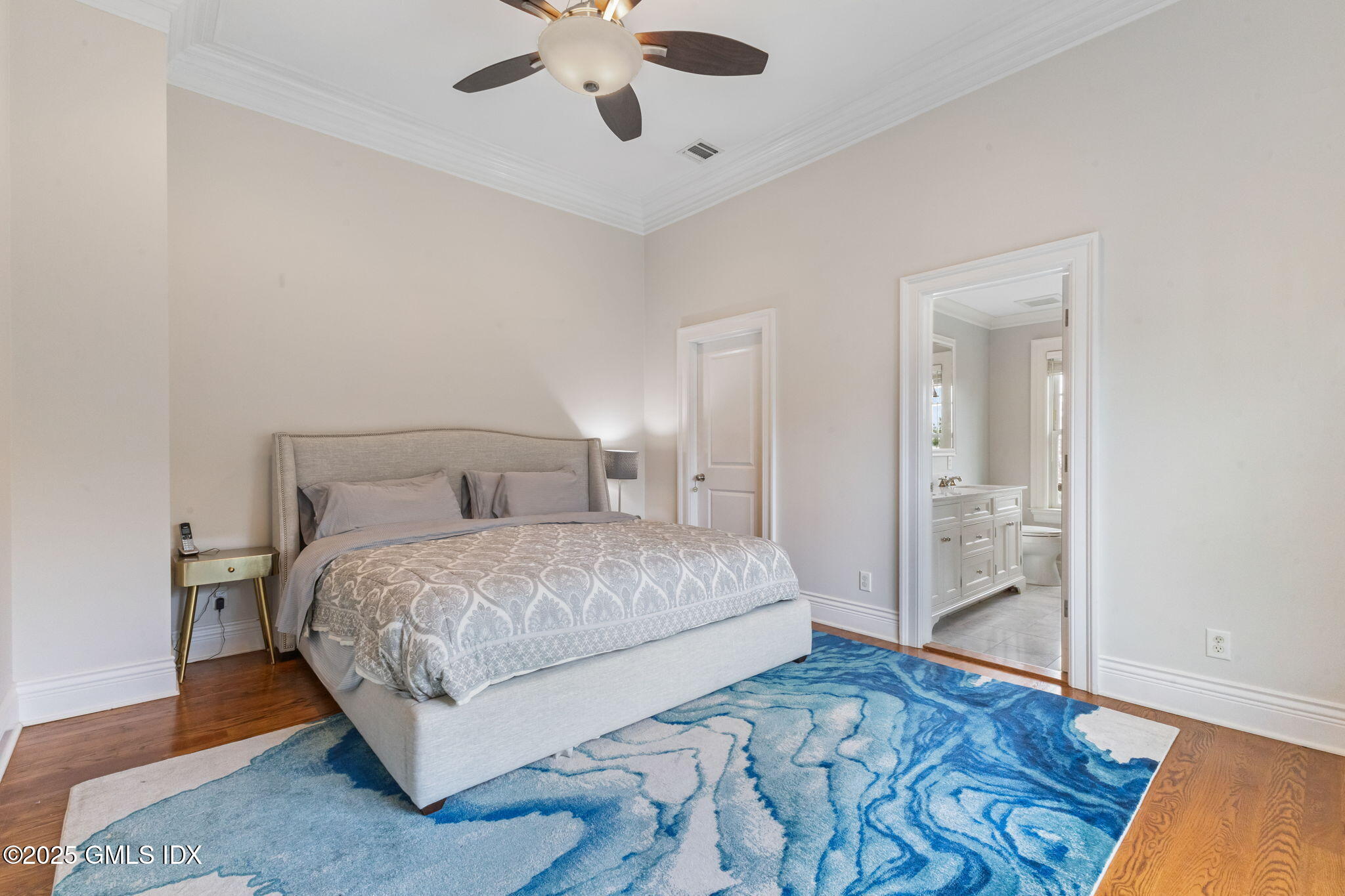26 Church Street, Unit B Greenwich, CT 06830 - Photo 17 of 30 a bedroom with a large bed and a chandelier