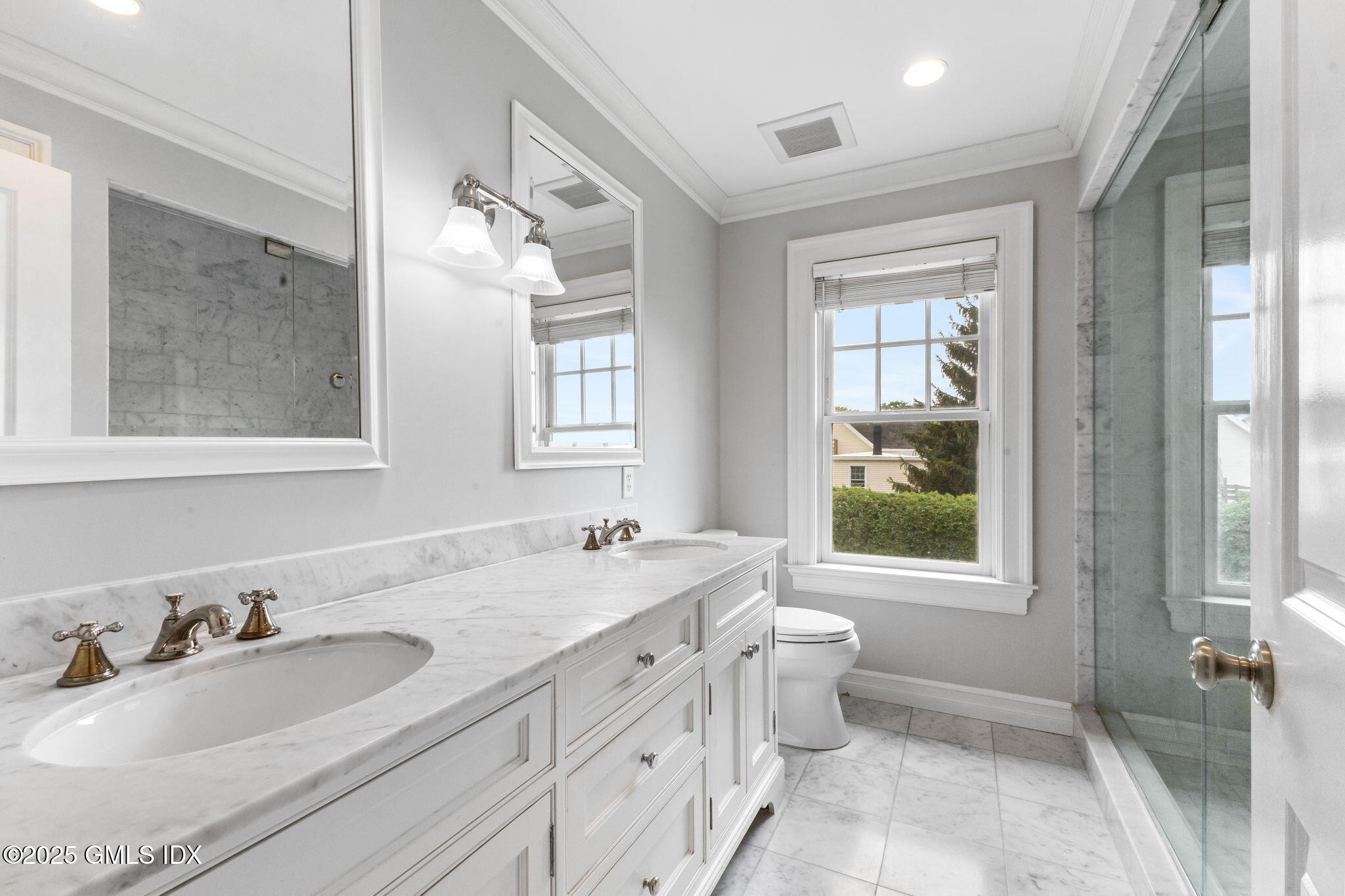 26 Church Street, Unit B Greenwich, CT 06830 - Photo 18 of 30 a bathroom with a double vanity sink toilet mirror and next to a window