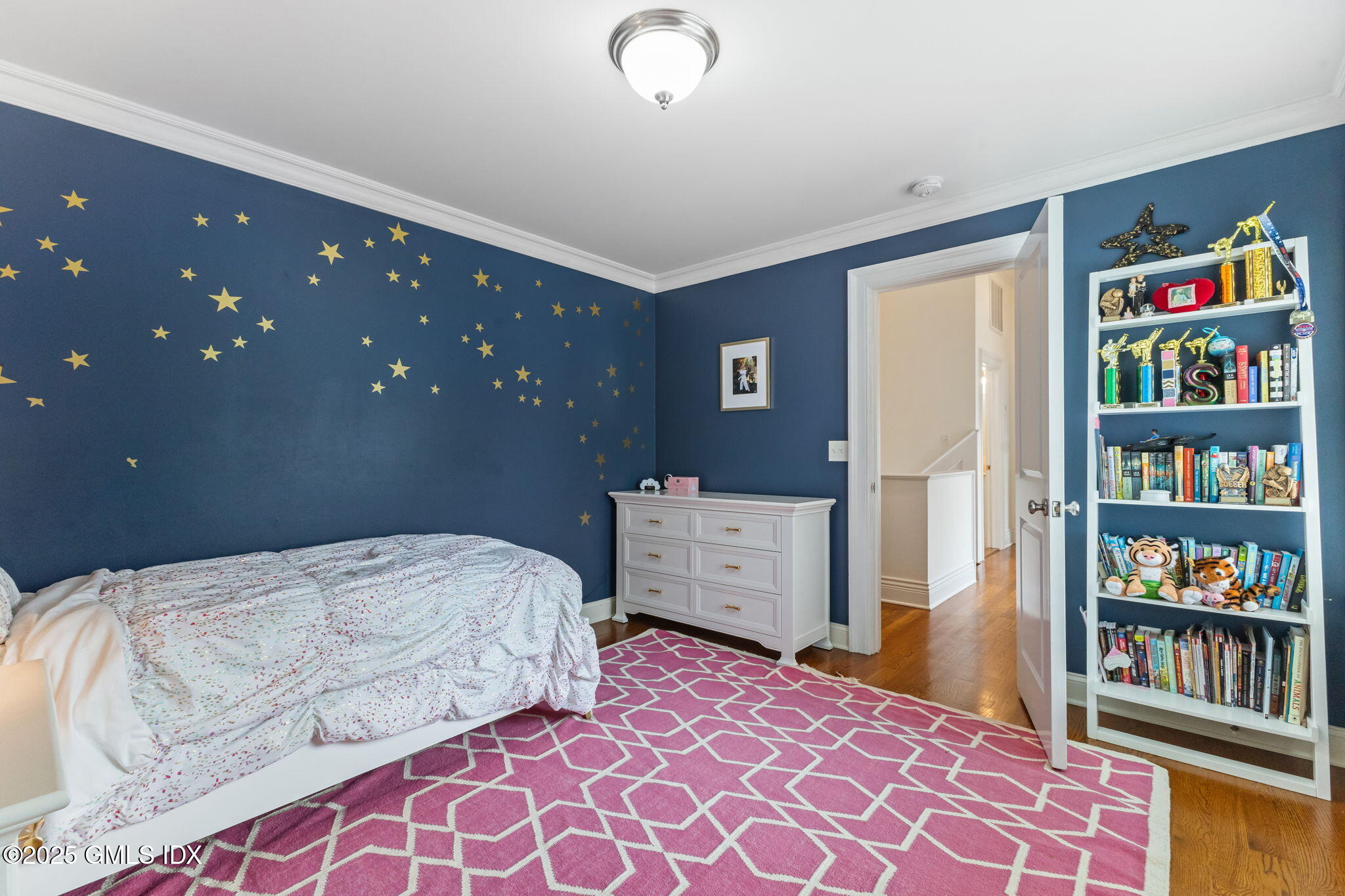 26 Church Street, Unit B Greenwich, CT 06830 - Photo 21 of 30 a bedroom with a bed and a book shelf